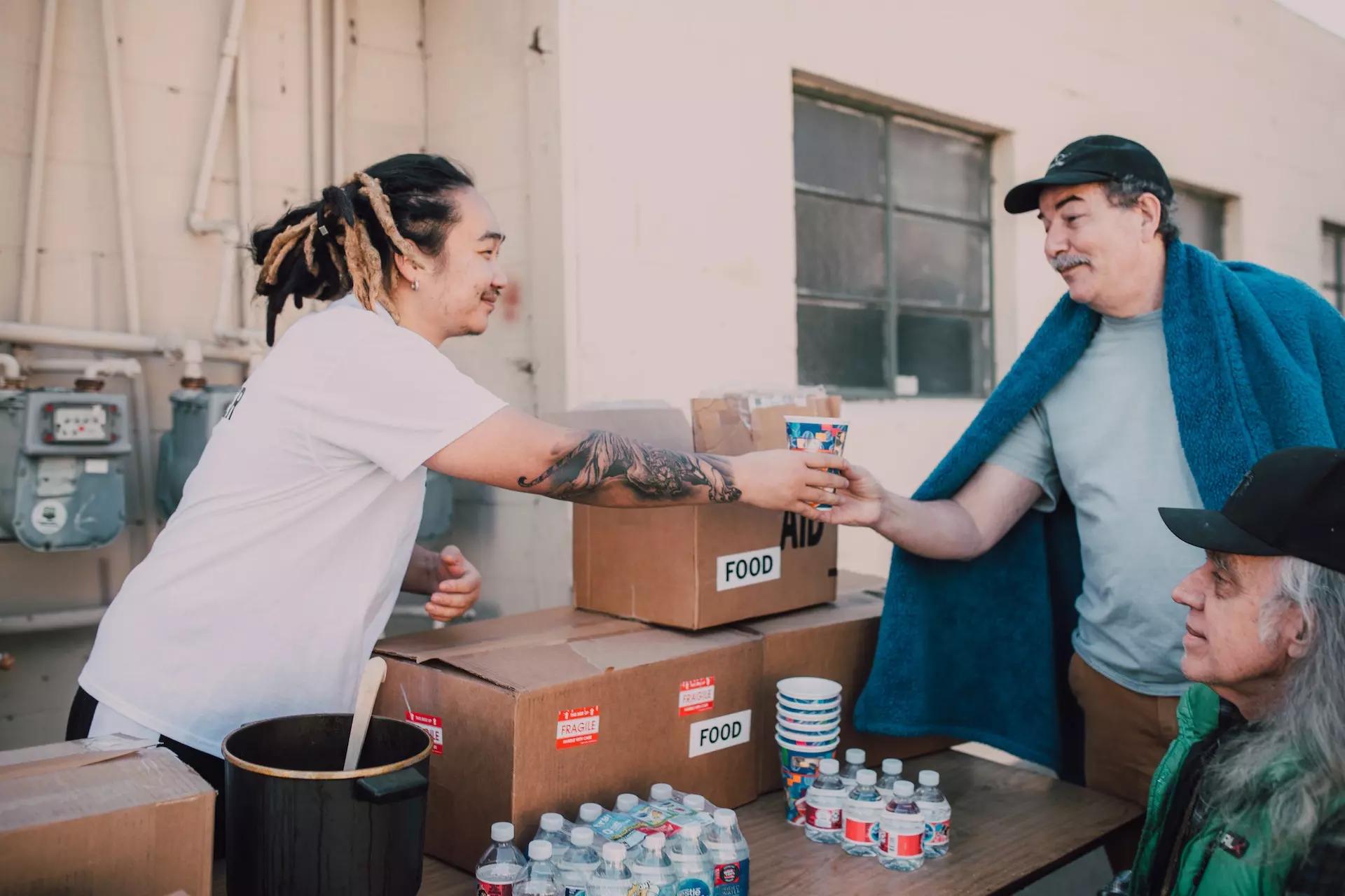 a person serving food to two other people