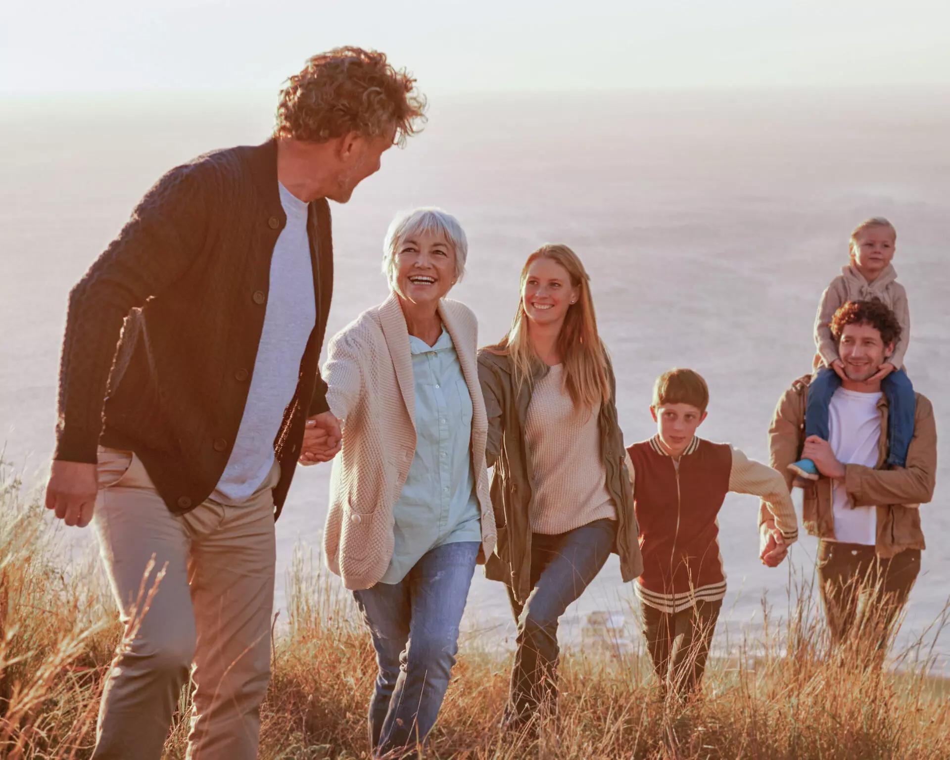 Multi-generational family walking up hill discussing donor advised funds and generosity