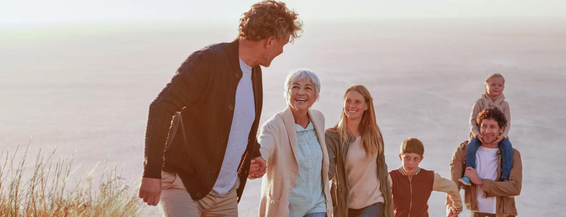multi-generational family walks up a hill discussing donor advised funds