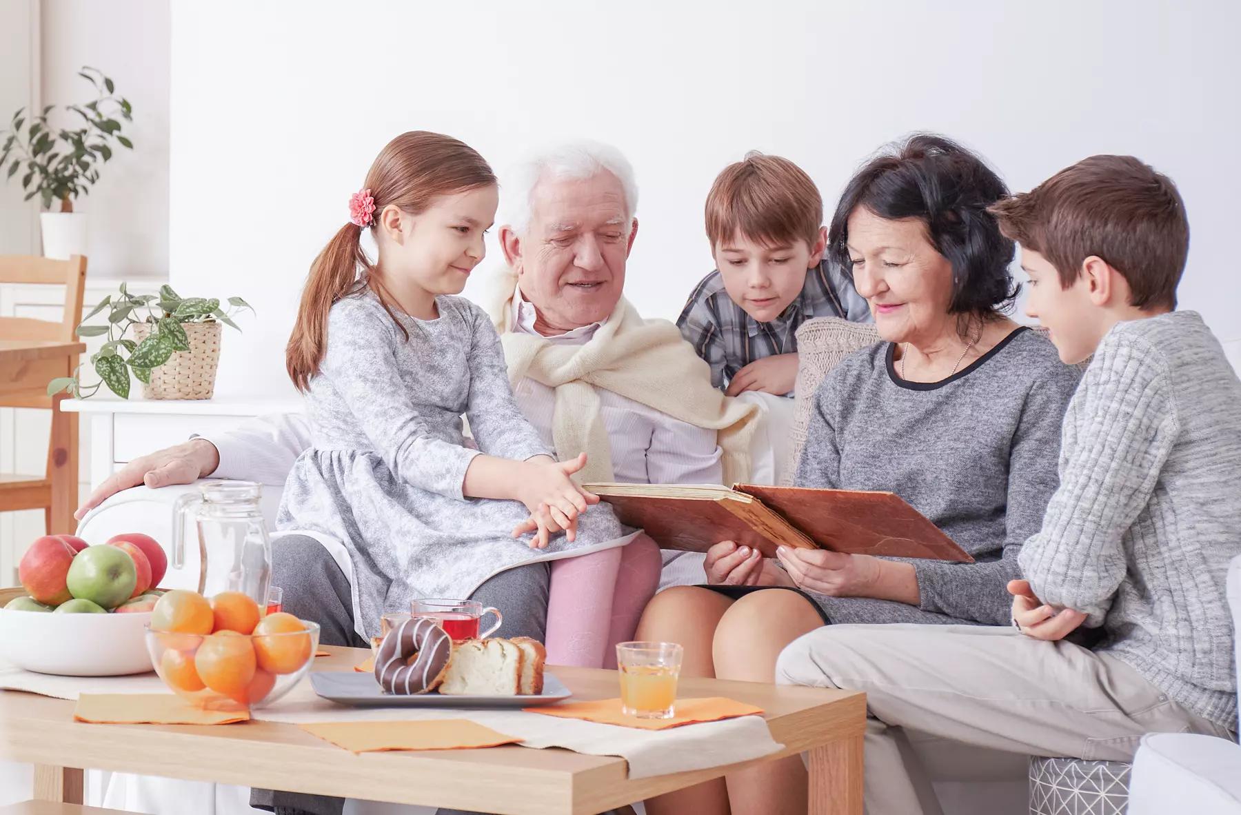 grandparents sitting with three grandchildren discussing their family legacy