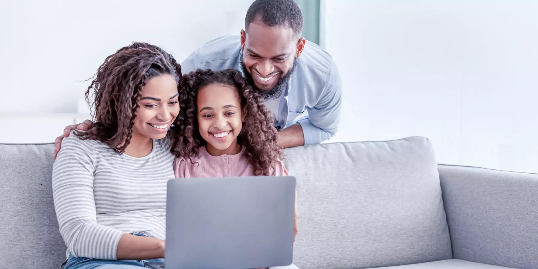 family sitting on the couch together on the computer setting up their donor advised fund