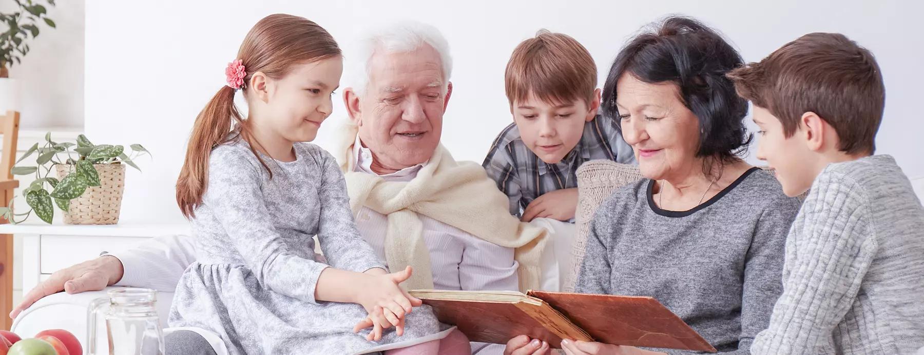 grandparents and grandchildren huddled around a book discussing family legacy