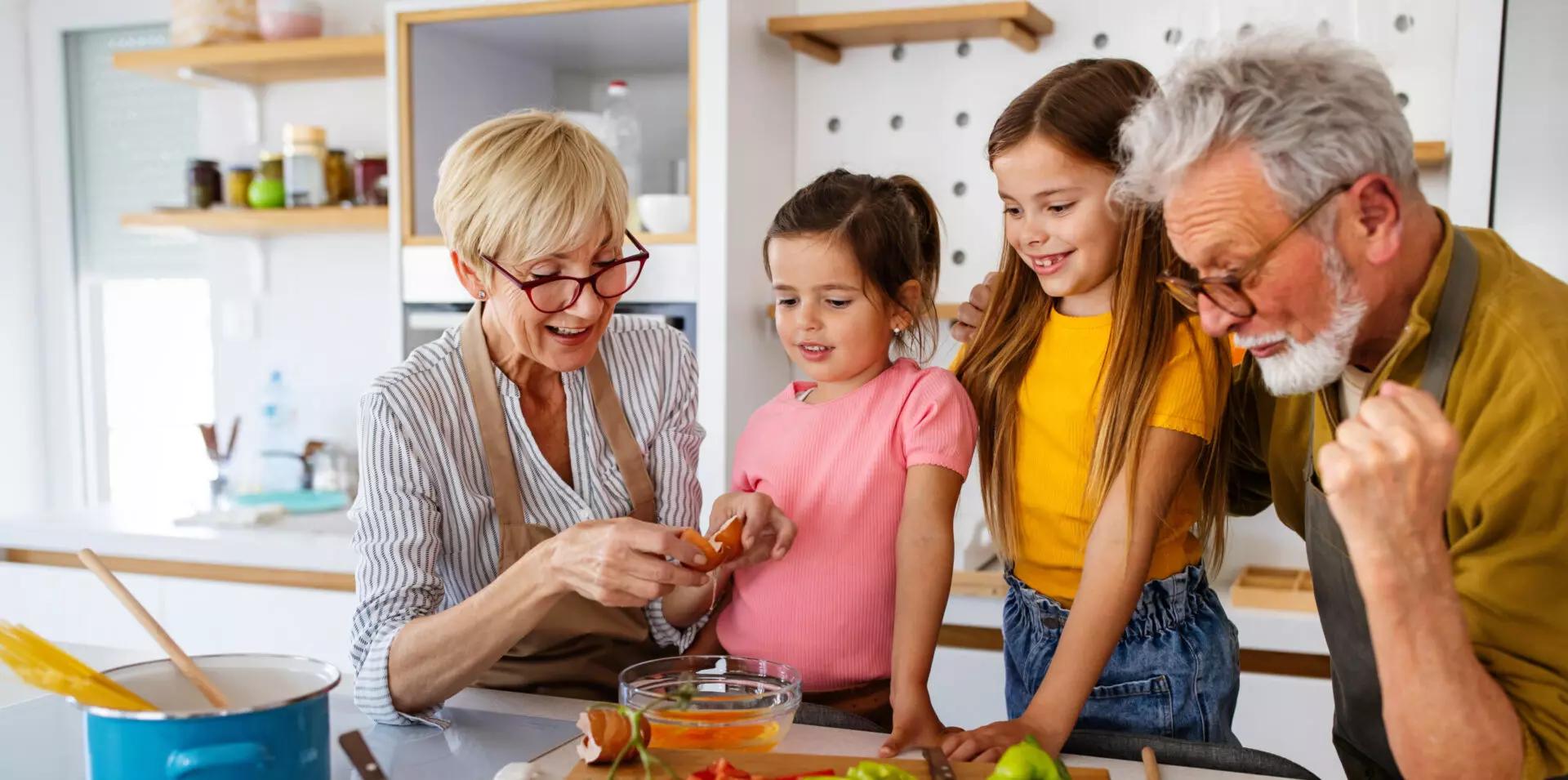 grandparents and grandchildren working on acts of generosity by baking together