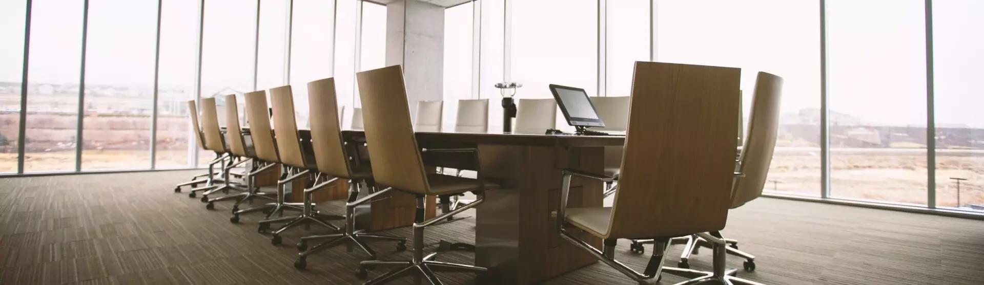 a table and chairs in an office board room